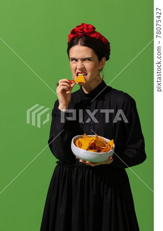 Young woman in art action remaking greatest paintings on green background. Retro style, comparison of eras concept. Young woman in art action remaking greatest paintings on green background. Retro style, comparison of eras concept. 78075427