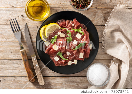 Marbled beef carpaccio on black plate Marbled beef carpaccio on black plate 78078741