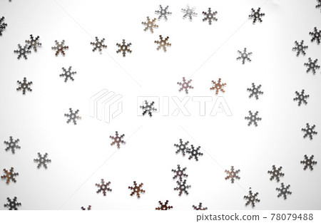 small shiny silver snowflakes on a gray background 78079488