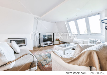 Spacious living room with gray sofa 78080452