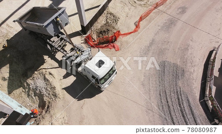 Beams With Steel Reinforcement. Dump Truck Unloads Sand in Construction. Aerial view. Unloading soil. Reinforced Concrete Frame Of An Industrial Building. Camera Flight On A Construction Site. Beams With Steel Reinforcement. Dump Truck Unloads Sand in Construction. Aerial view. Unloading soil. Reinforced Concrete Frame Of An Industrial Building. Camera Flight On A Construction Site. 78080987
