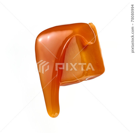 caramel sauce flowing on flying caramel candy 78080994