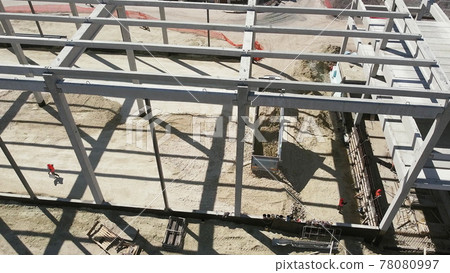 Reinforced Concrete Frame Of An Industrial Building. Camera Flight On A Construction Site. Beams With Steel Reinforcement. Dump Truck Unloads Sand in Construction. Aerial view. Unloading soil Reinforced Concrete Frame Of An Industrial Building. Camera Flight On A Construction Site. Beams With Steel Reinforcement. Dump Truck Unloads Sand in Construction. Aerial view. Unloading soil 78080997