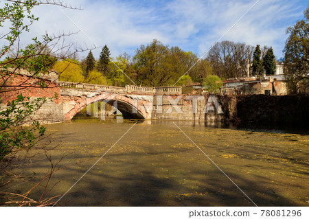 Old arched brick bridge across a pond in Sharovka Palace park in in Kharkov region, Ukraine Old arched brick bridge across a pond in Sharovka Palace park in in Kharkov region, Ukraine 78081296