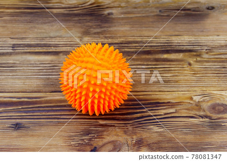 Orange dog toy ball on wooden background Orange dog toy ball on wooden background 78081347