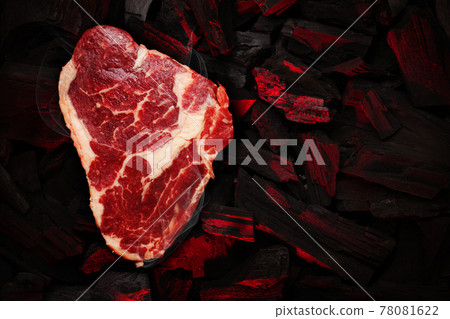 Ribeye steak over hot coal 78081622