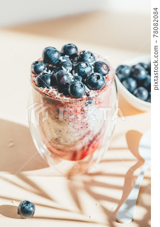 Healthy chia pudding in a glass with fresh blueberries Healthy chia pudding in a glass with fresh blueberries 78082084