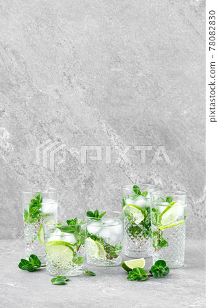 Mint and lime refreshing mojito cocktail with ice, refreshment citrus drink. Mint and lime refreshing mojito cocktail with ice, refreshment citrus drink. 78082830