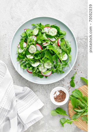 Fresh vegetarian vegetable salad with radish, cucumber and arugula, healthy food, top view. 78082839