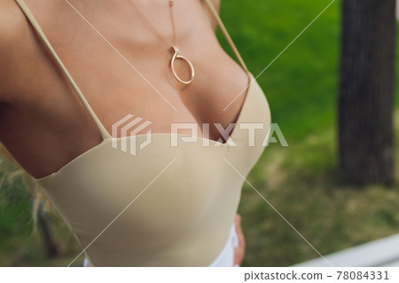 Decollete, female breast. Neckline white dress and fur collar. Decollete, female breast. Neckline white dress and fur collar. 78084331