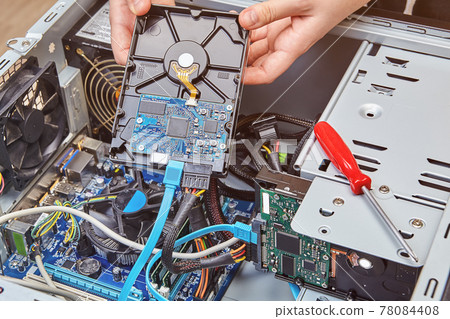 Removing computer hard drive from system unit to replace it with new one. Removing computer hard drive from system unit to replace it with new one. 78084408