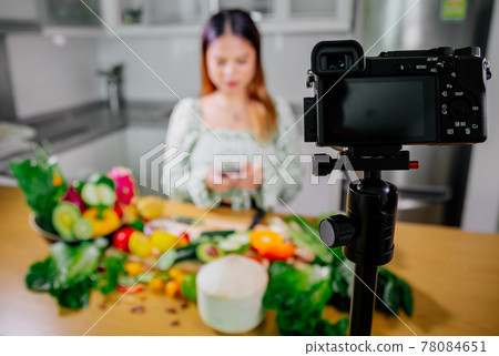 Asian woman blogger or content creator cooking and recording video camera. showing healthy food 78084651
