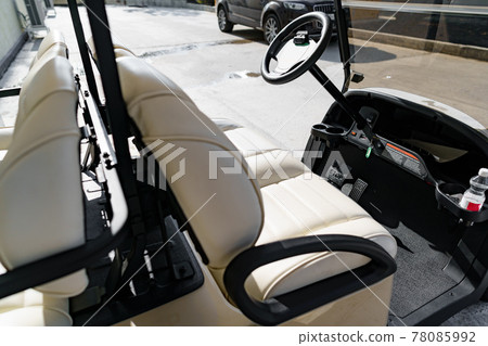 Electric golf car parked near hotel building Electric golf car parked near hotel building 78085992