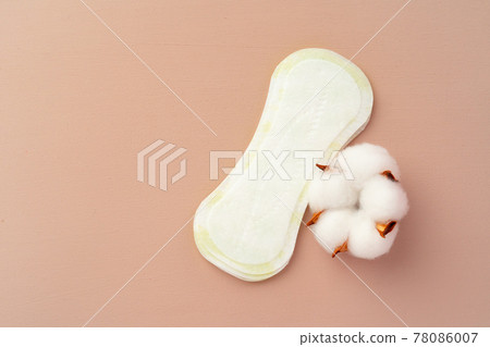 Women medical pads and cotton flower on paper background 78086007