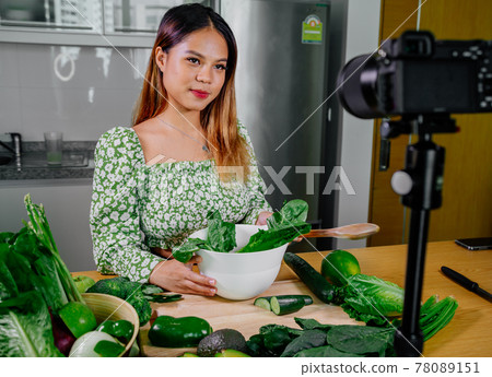 Asian woman blogger or content creator cooking and recording video camera. showing healthy food 78089151