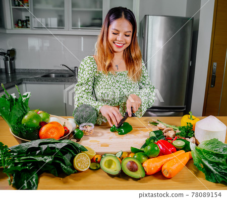 Asian girl cooking healthy vegetarian and vegan food, vegetables and fruits in the kitchen, healthy 78089154