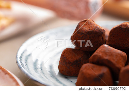 Close up of chocolate truffel candies on plate Close up of chocolate truffel candies on plate 78090792