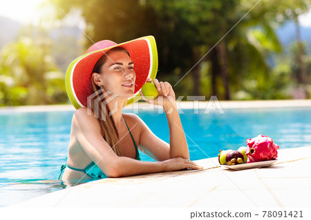 Woman with laptop at swimming pool. Remote work. Woman with laptop at swimming pool. Remote work. 78091421