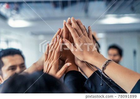 Many happy business people raise hands together. Many happy business people raise hands together. 78091899