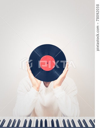 man holding record with piano on desk. music background man holding record with piano on desk. music background 78092038
