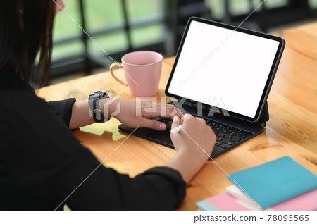 Cropped shot female using mockup digital tablet in case with empty screen. Cropped shot female using mockup digital tablet in case with empty screen. 78095565