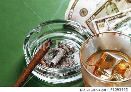 Cuban cigar and money on green background Cuban cigar and money on green background 78095855