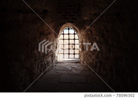 Window with bars in the old fortress 78096302