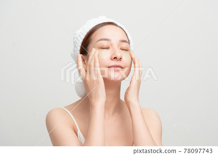 Surprised face woman touch patches under eyes 78097743