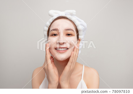 emotional funny girl is looking at the mirror. close up photo. studio shot. grey background emotional funny girl is looking at the mirror. close up photo. studio shot. grey background 78097810