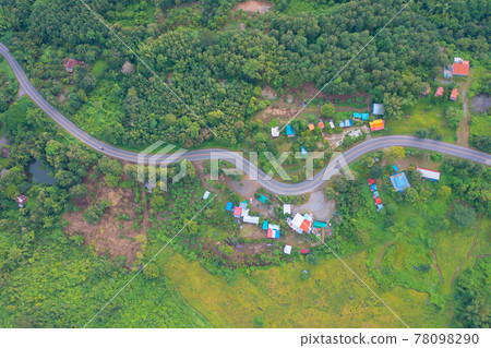 Aerial view of cars driving on curved, zigzag curve road or street on mountain hill with green natural forest trees in rural area of Phu Tub Berk, Phetchabun, Thailand. Aerial view of cars driving on curved, zigzag curve road or street on mountain hill with green natural forest trees in rural area of Phu Tub Berk, Phetchabun, Thailand. 78098290