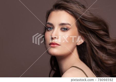 Portrait of perfect fashion model woman with clear skin on brown Portrait of perfect fashion model woman with clear skin on brown 78098592