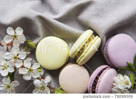 French sweet macaroons colorful variety on a gray textile background French sweet macaroons colorful variety on a gray textile background 78099309