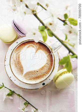 Coffee with a heart-shaped pattern and sweet macaroons desserts Coffee with a heart-shaped pattern and sweet macaroons desserts 78099700
