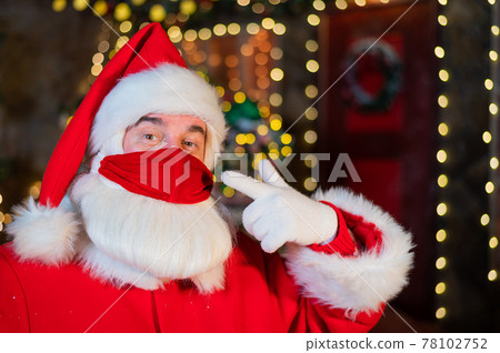 Portrait of santa claus wearing a protective mask. Winter holiday during the coronavirus pandemic 78102752