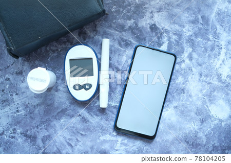 diabetic measurement tools and smart phone with empty screen  78104205