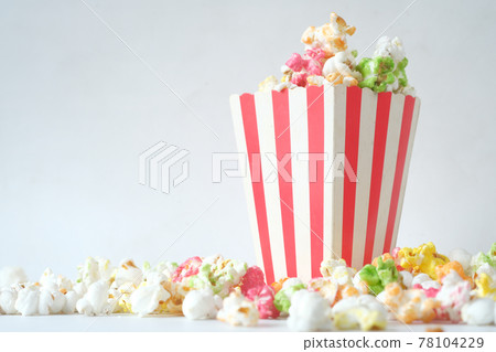 popcorn in a bowl on wooden desk with copy space  78104229