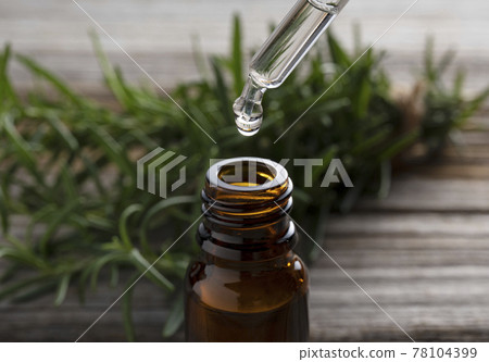 Essential oil bottle and rosemary Essential oil bottle and rosemary 78104399