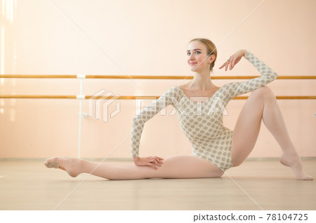 Graceful hyper-flexible ballerina is training in a dance class with ballet machines. Graceful hyper-flexible ballerina is training in a dance class with ballet machines. 78104725