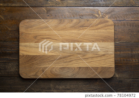 Empty rectangular cutting board on a wooden table. Space for text. 78104972
