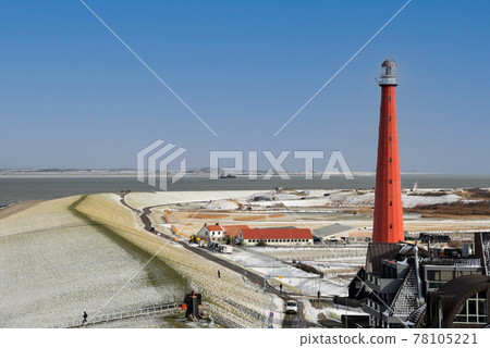 The lighthouse Lange Jaap of Huisduinen on a winterday. Den Helder, the Netherlands. The lighthouse Lange Jaap of Huisduinen on a winterday. Den Helder, the Netherlands. 78105221