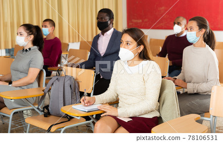 Group of adult students in protective masks at lecture at university 78106531