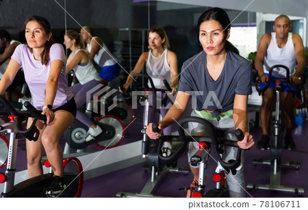 Adults working out of cycling in fitness club Adults working out of cycling in fitness club 78106711