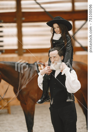 A little child riding a horse with an instructor A little child riding a horse with an instructor 78108096