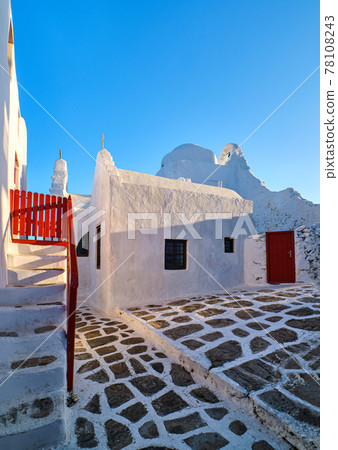 Backyard of main tourist landmark, Mykonos, Greece, white Greek Orthodox church of Panagia Paraportiani, at sunrise. Iconic destination Backyard of main tourist landmark, Mykonos, Greece, white Greek Orthodox church of Panagia Paraportiani, at sunrise. Iconic destination 78108243