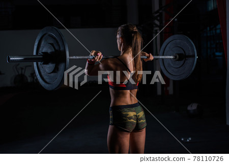 European muscular young fitness woman in khaki shorts doing heavy deadlift exercise in crossfit gym European muscular young fitness woman in khaki shorts doing heavy deadlift exercise in crossfit gym 78110726