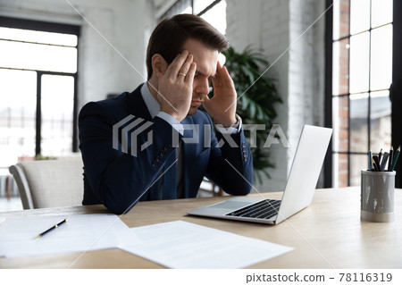 Focused businessman pondering on problem, thinking hard Focused businessman pondering on problem, thinking hard 78116319