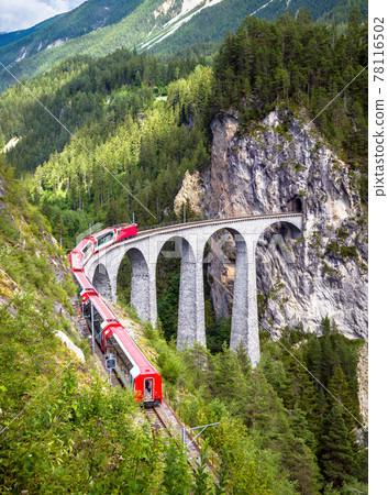 Rhaetian express moves on Landwasser Viaduct, Switzerland 78116502