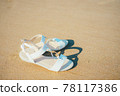 Sandals placed on the sandy beach 78117386