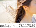 Profile of a woman whose hair flutters in the wind 78117389