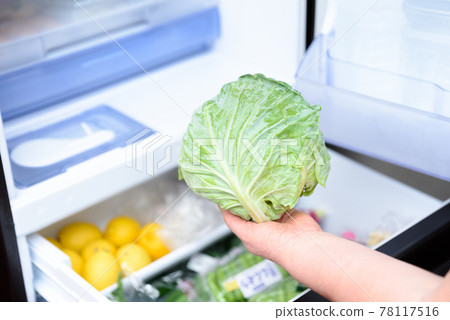 A Woman S Hand Taking Out Cabbage From The Refrigerator For Cooking   78117516 